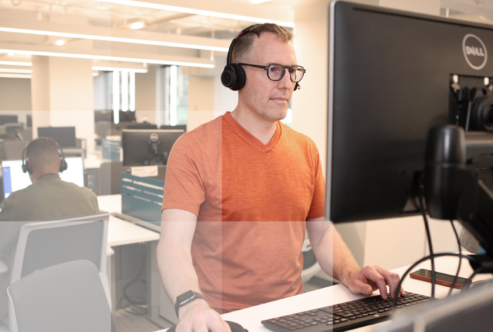 Datasite virtual data room user accessing Datasite Assist at his desk via a desktop computer