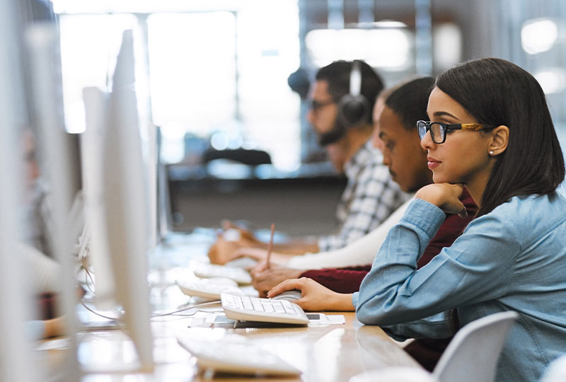 Woman accessing virtual data room certification for universities offered by Datasite via desktop computer