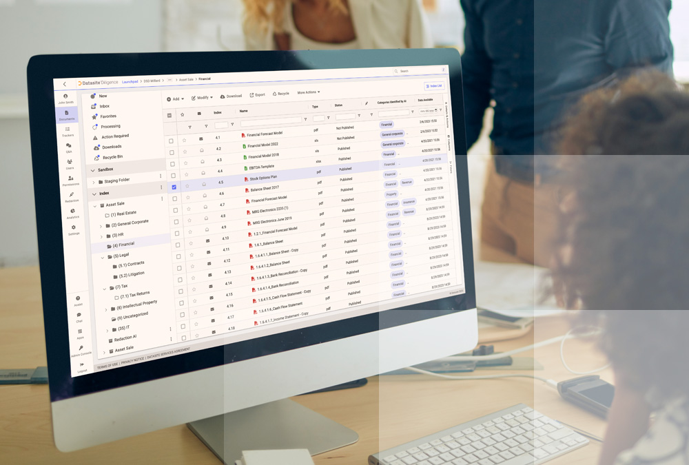 Desktop computer displaying software and the Datasite due diligence data room platform